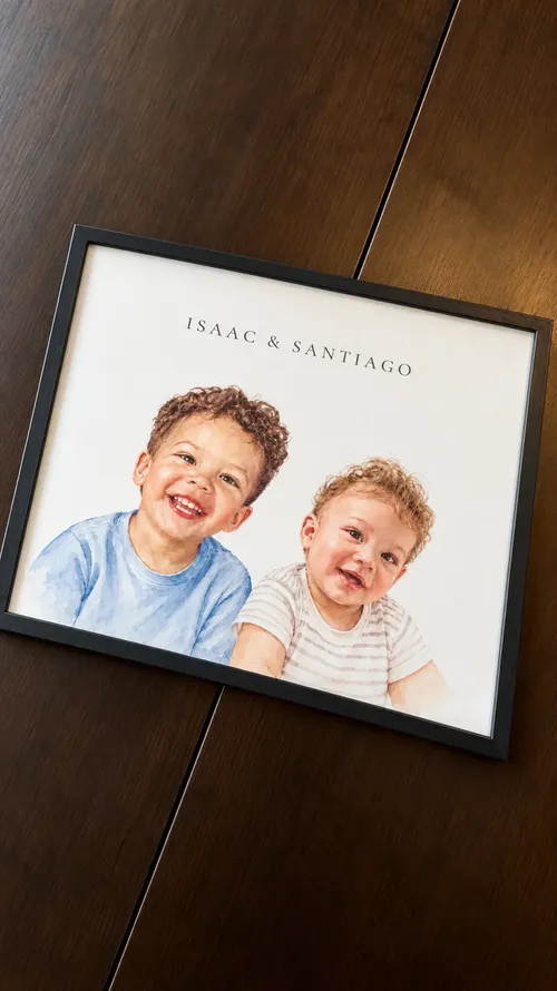 Isaac & Santiago's framed two-child portrait on a wood table