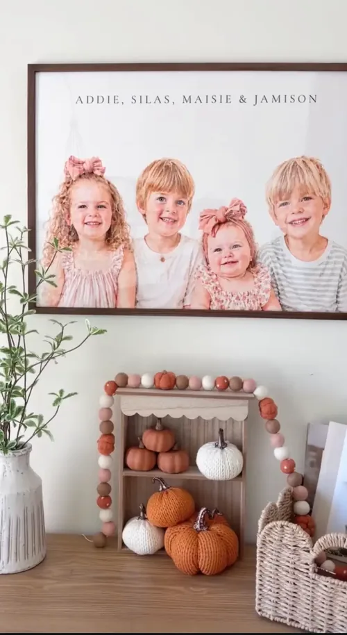 Four siblings' portrait in a walnut frame above a fall console table